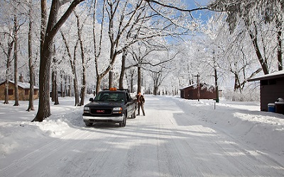 Truck on Plowed Road with Snow on Trees and Ground